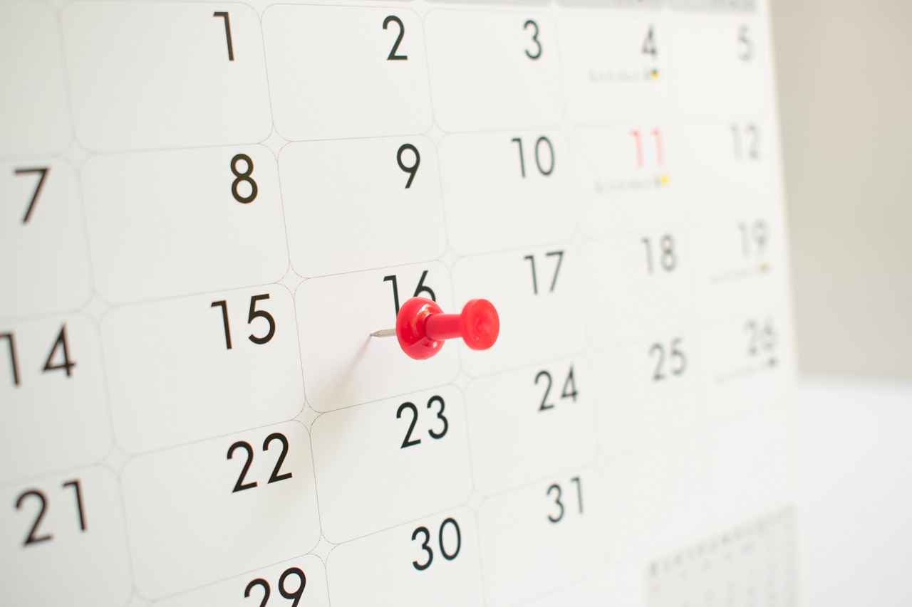 A calendar with a red pin