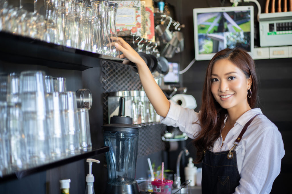 A young woman in her new coffee shop business