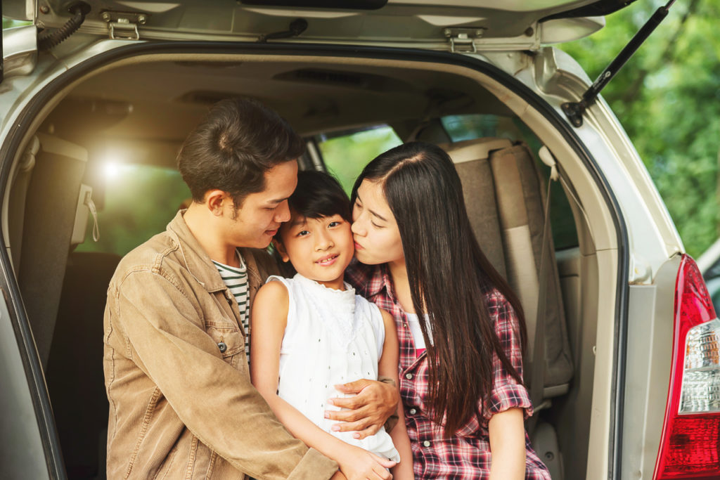 An asian family on a roadtrip with new car