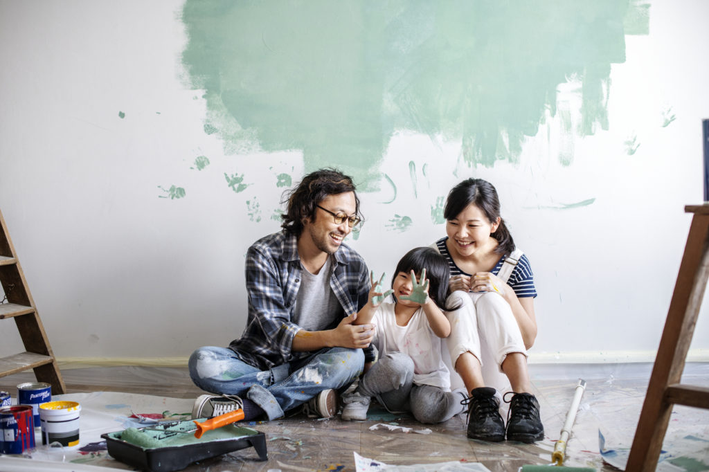 A happy family painting their home's walls