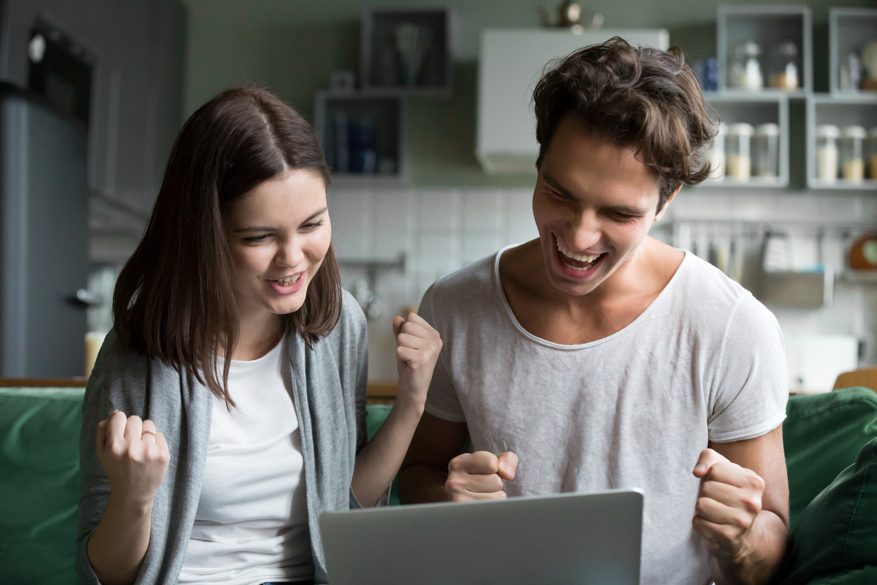 A couple celebrating their approved online loan