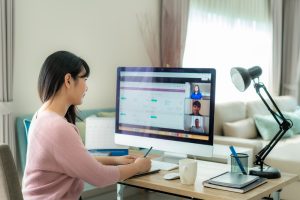 asian business woman talking to her colleagues about plan in video call