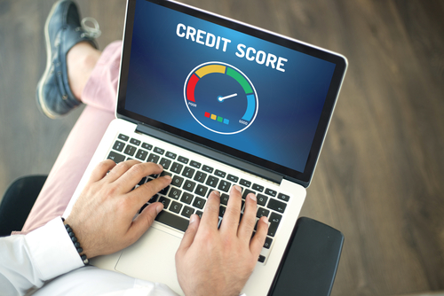 Man using laptop and CREDIT SCORE concept on screen
