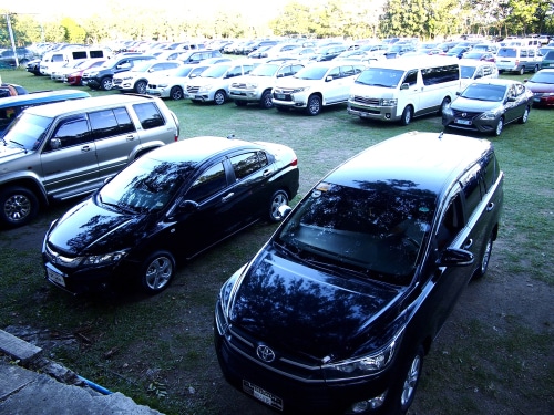 Several cars are parked in a parking lot.